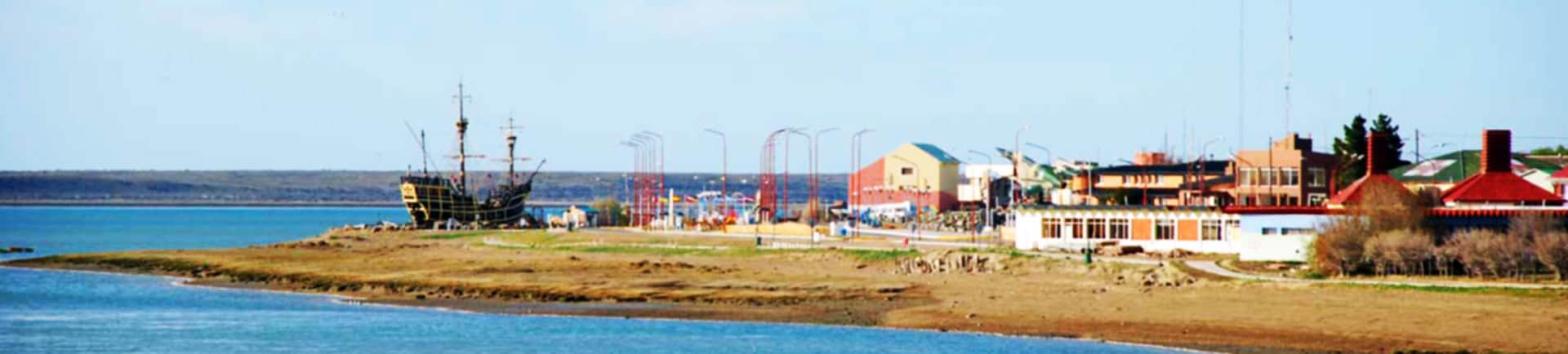 Coastal view of El Kaminante with ships and buildings on the shore, showcasing the scenic beauty of.