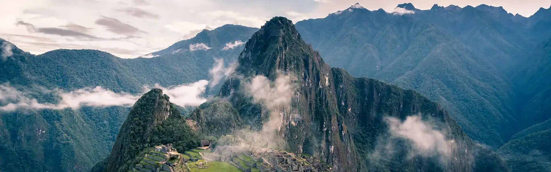 Montañas y Machu Picchu en Perú, con nubes y paisaje impresionante.