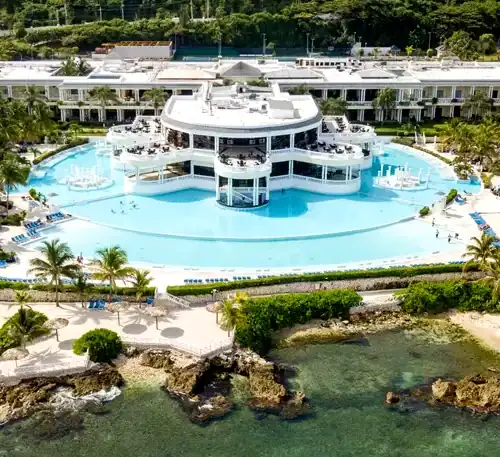 Luxury resort with large swimming pool and tropical surroundings in the Caribbean.