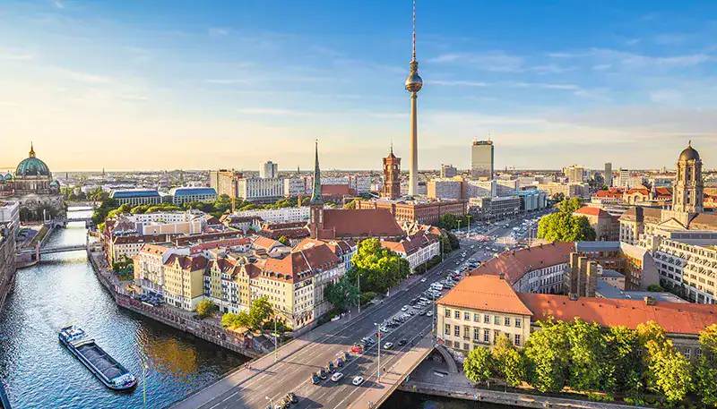 Berlin cityscape with TV Tower and river view at sunset.