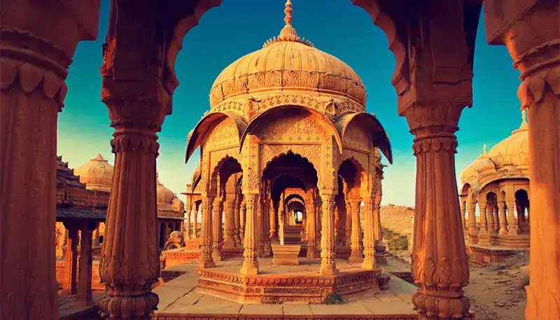 Ancient Indian monument with intricate stone carvings and domed architecture.