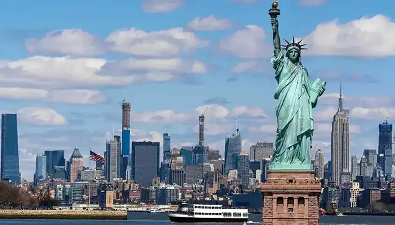 Statue of Liberty with New York City skyline in the background.