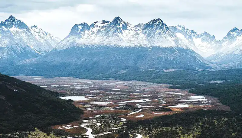 Snow-capped mountains and lush valley in Patagonia, Argentina.